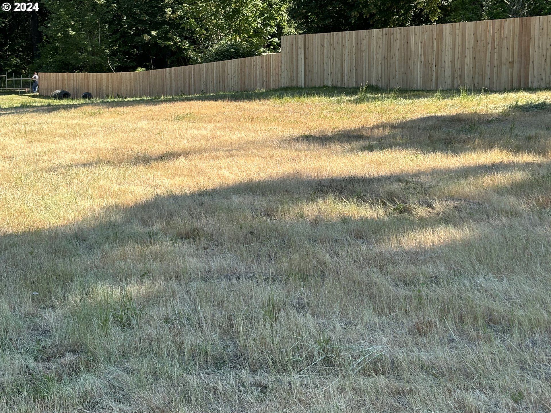 a view of swimming pool with wooden fencing