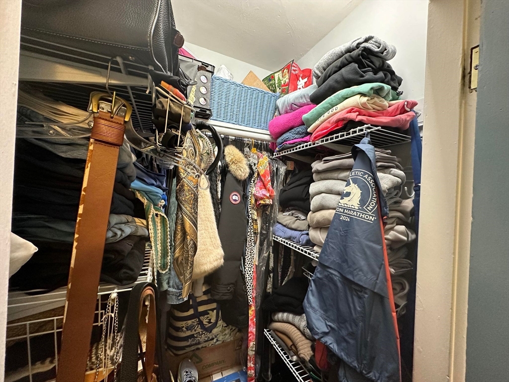 88 Charles Street, Unit 5 Boston, MA 02114 - Photo 13 of 15 a view of walk in closet with clothes and shoes