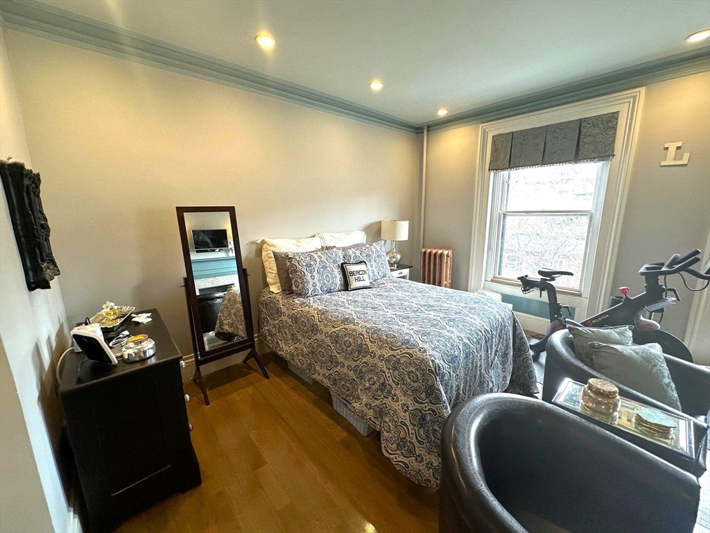 88 Charles Street, Unit 5 Boston, MA 02114 - Photo 2 of 15 a spacious bedroom with a bed and a couch