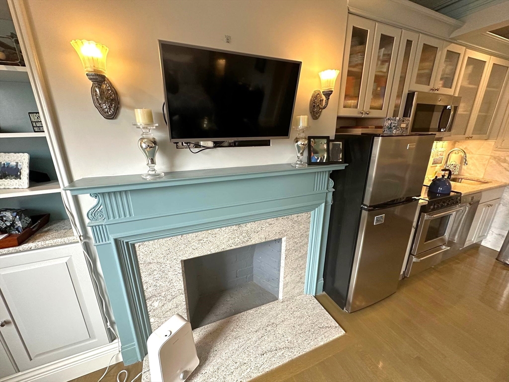 88 Charles Street, Unit 5 Boston, MA 02114 - Photo 5 of 15 a living room with furniture and a flat screen tv