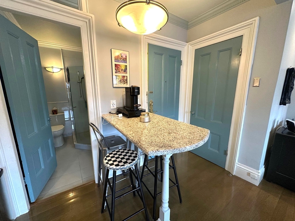 88 Charles Street, Unit 5 Boston, MA 02114 - Photo 6 of 15 a view of a dining room with furniture and wooden floor
