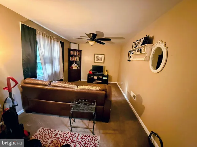 a bedroom with bed and wooden floor