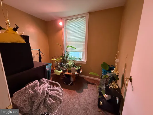 a bedroom with furniture and a chair