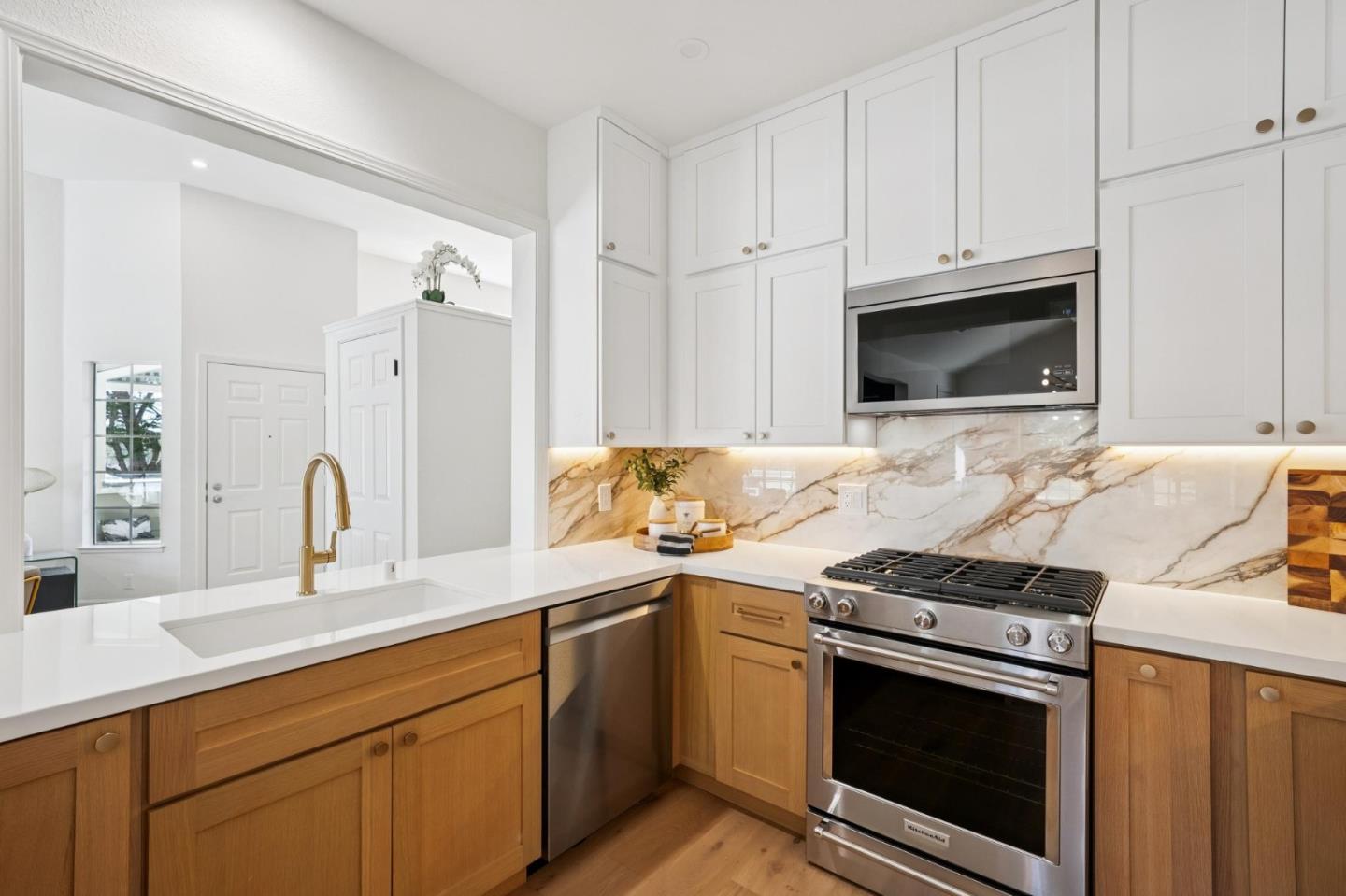 135 Troon Way Half Moon Bay, CA 94019 - Photo 13 of 44 a kitchen with stainless steel appliances a stove a sink and a microwave
