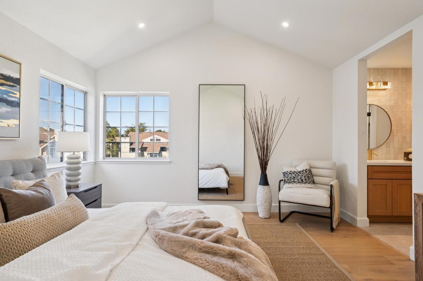 135 Troon Way Half Moon Bay, CA 94019 - Photo 21 of 44 a bedroom with a bed and a chair