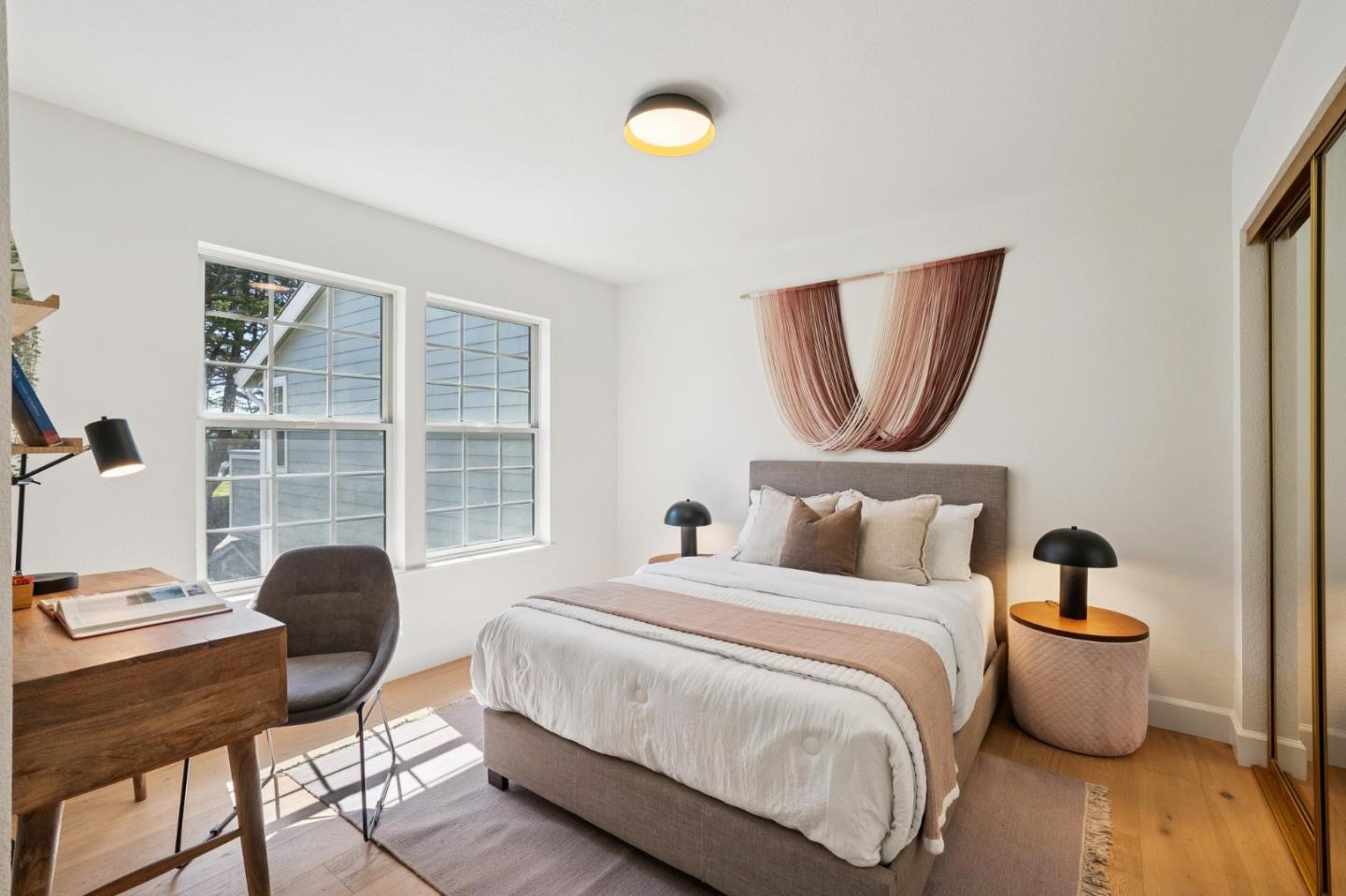 135 Troon Way Half Moon Bay, CA 94019 - Photo 29 of 44 a bedroom with a bed a chair and a large window