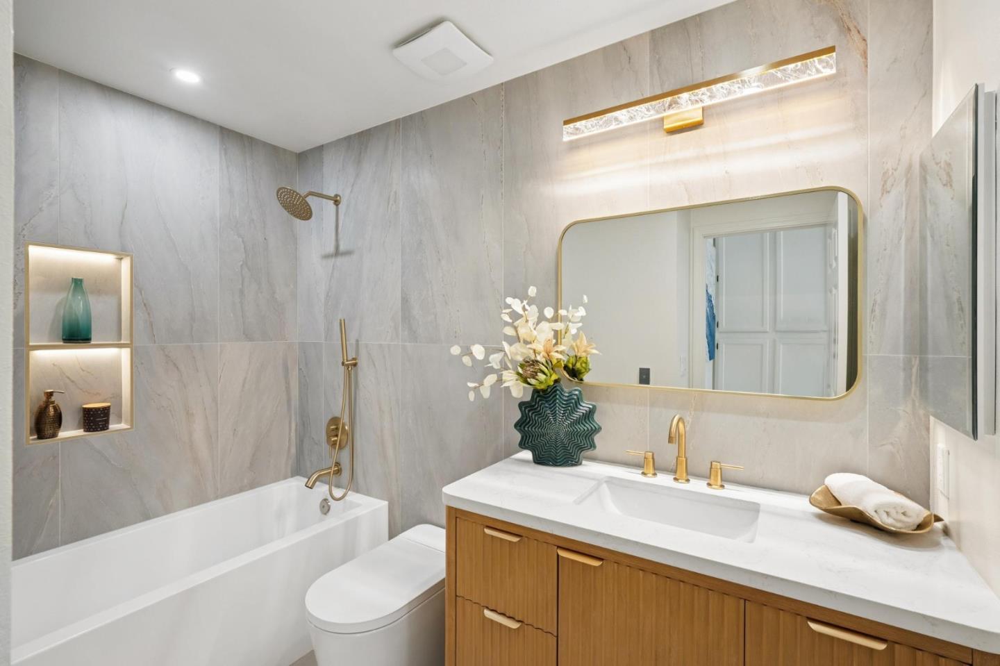 135 Troon Way Half Moon Bay, CA 94019 - Photo 31 of 44 a bathroom with a granite countertop sink toilet a large mirror a shower and bathtub