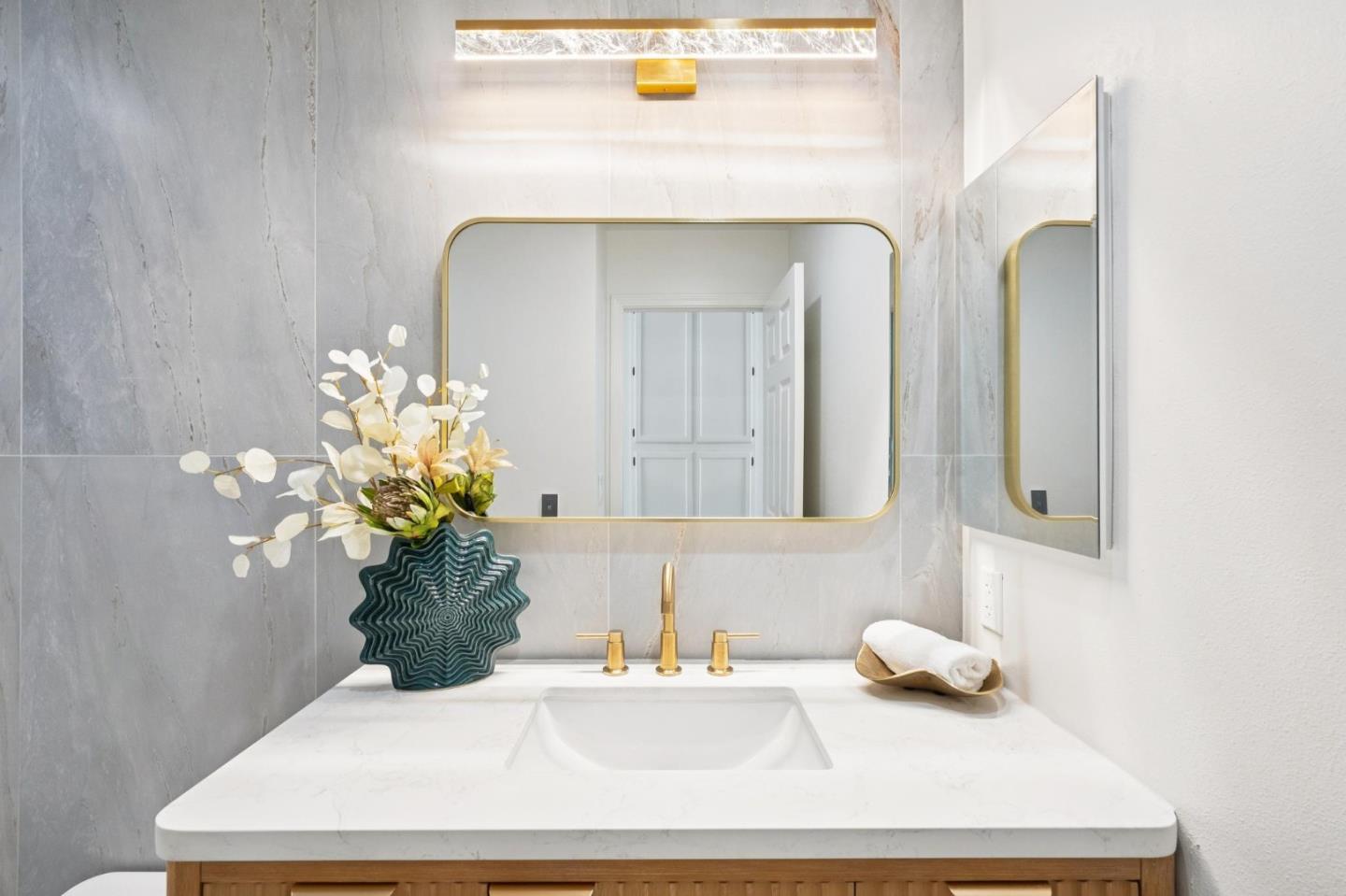 135 Troon Way Half Moon Bay, CA 94019 - Photo 32 of 44 a bathroom with a sink a vanity and a mirror