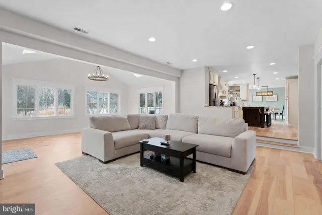a kitchen with a stove and a wooden floor