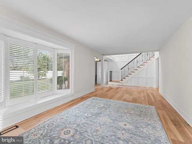 a kitchen with stainless steel appliances kitchen island granite countertop a table chairs refrigerator and sink