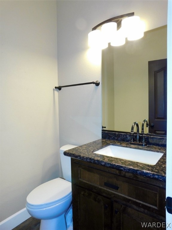 4822 La Riqueza Road Fort Mohave, AZ 86426 - Photo 31 of 35 a bathroom with a granite countertop sink toilet and mirror