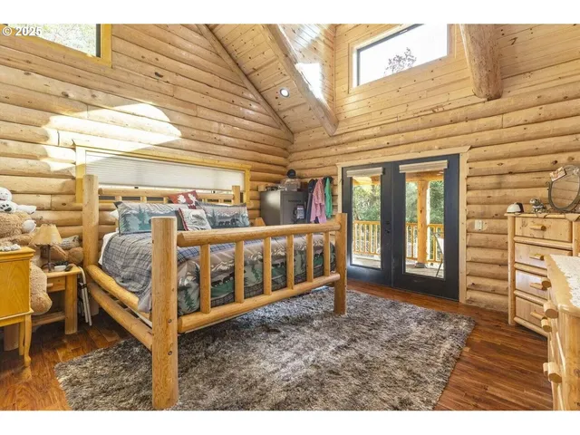 a view of a room with a large window and bed