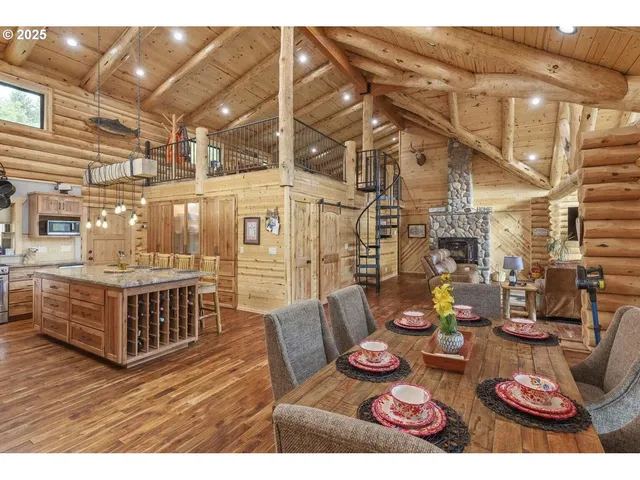 a living room with furniture a large window and wooden floor