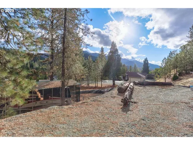 a backyard of a house with table and chairs