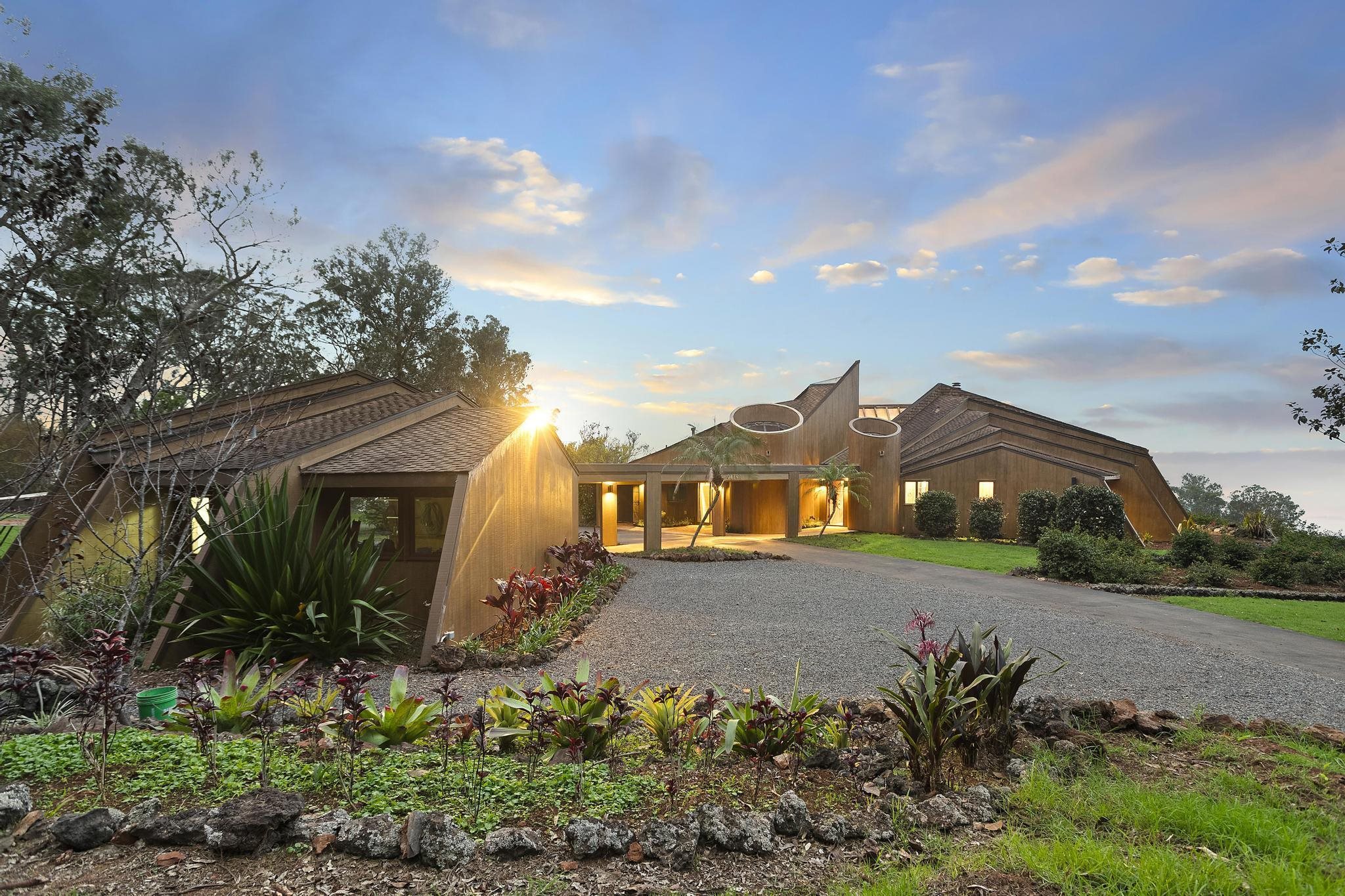 2450 Piiholo Road Makawao, HI 96768 - Photo 1 of 39 a front view of a house with a yard and potted plants