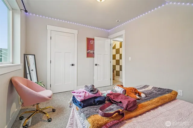 a bedroom with a large bed and a window