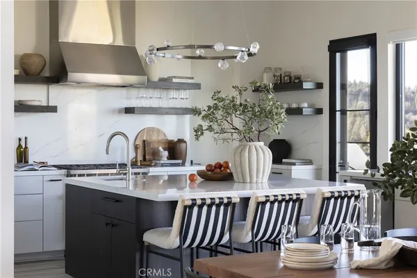 a kitchen with a table chairs sink and cabinets