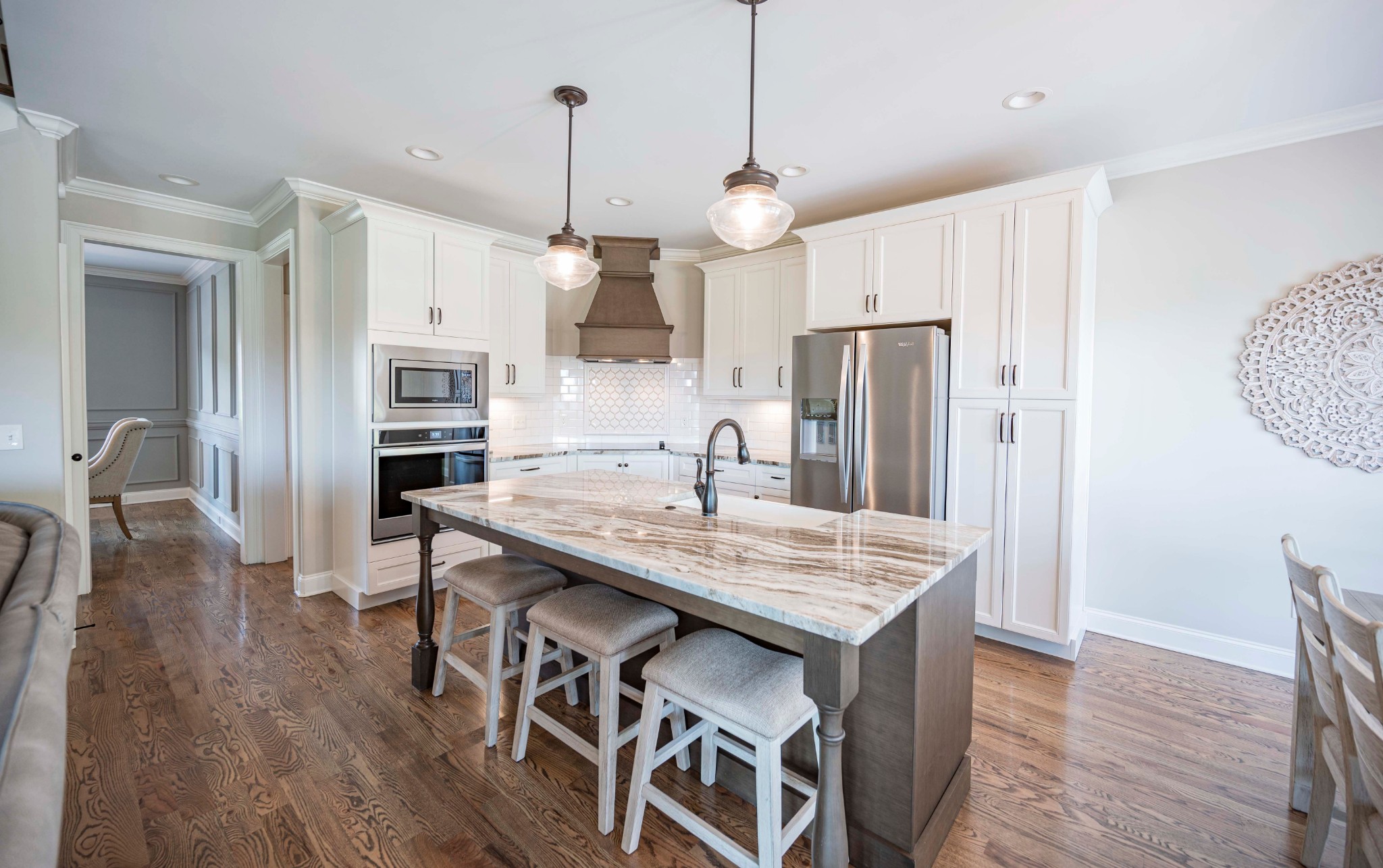 128 Seclusion Court Murfreesboro, TN 37129 - Photo 12 of 68 a kitchen with stainless steel appliances granite countertop a refrigerator a sink dishwasher a oven a dining table and chairs with wooden floor