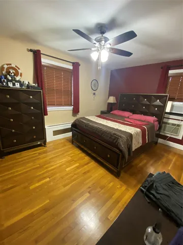 a spacious bedroom with a bed and dresser