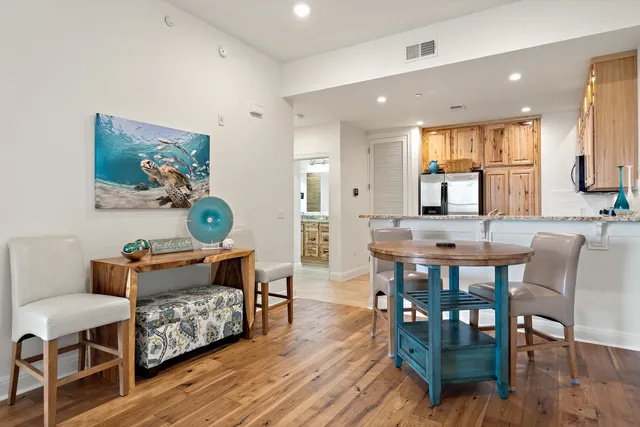 a view of a dining room with furniture and wooden floor