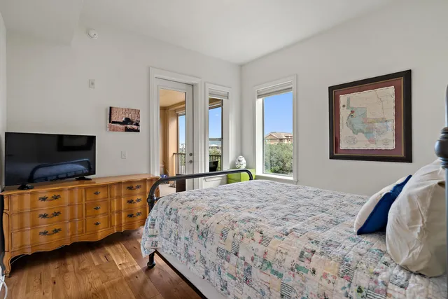 a bedroom with a bed and flat screen tv