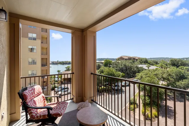 a view of a balcony with chair and wooden floor