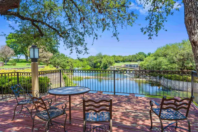 a view of a lake with a bench in patio
