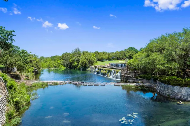 a view of a lake with houses in the back