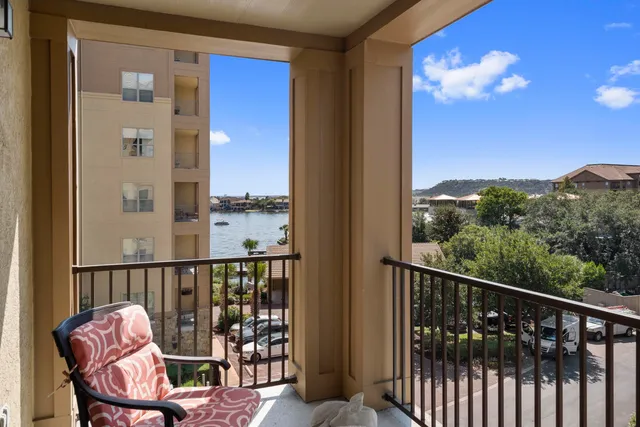a view of a balcony with chair and city view