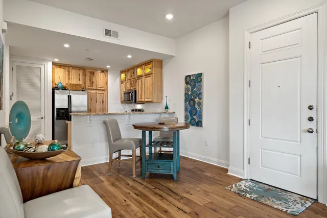 a living room with furniture a wooden floor and next to a window