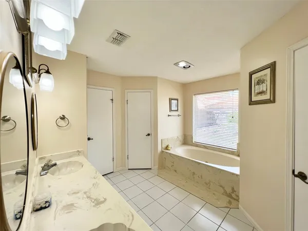 a spacious bathroom with a tub shower and sink