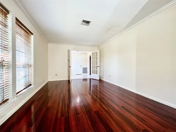 a view of a room with wooden floor and window