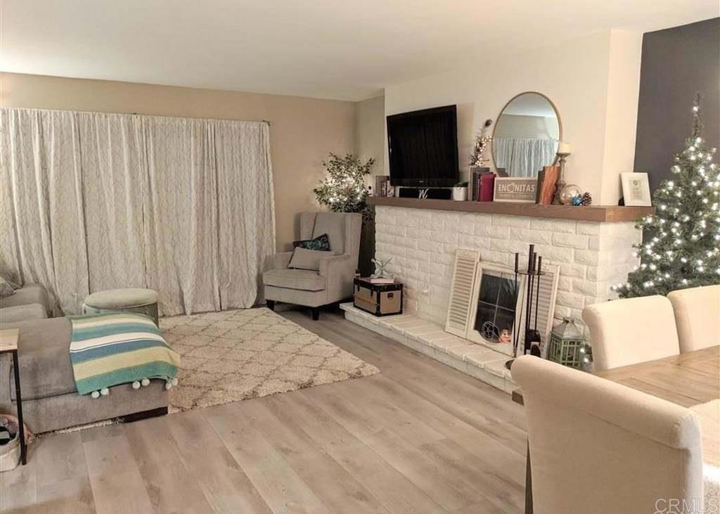 31908 Del Cielo Este, Unit 3A Bonsall, CA 92003 - Photo 4 of 8 a living room with furniture and a fireplace