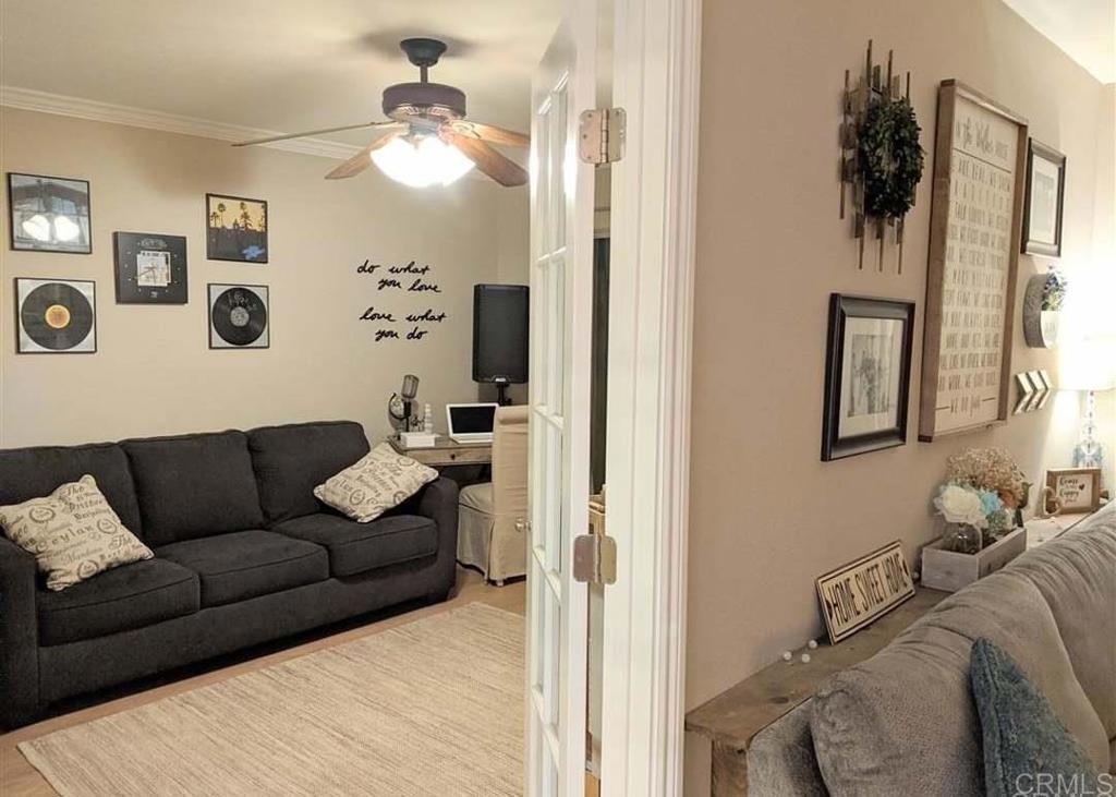 31908 Del Cielo Este, Unit 3A Bonsall, CA 92003 - Photo 5 of 8 a living room with furniture and a mirror