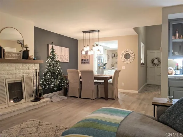 a living room with furniture a fireplace and a chandelier