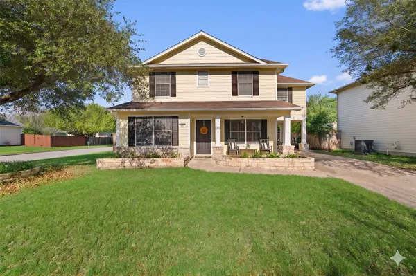 a front view of a house with swimming pool and garden