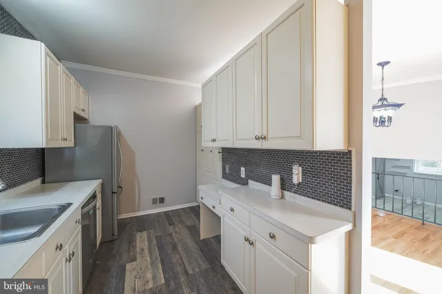 a kitchen with a sink a stove and cabinets