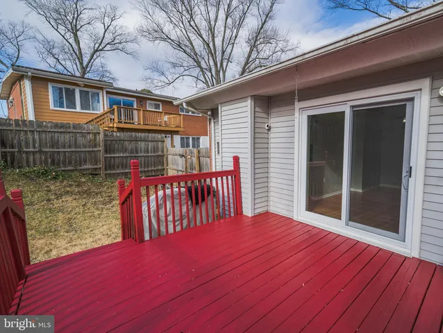 a backyard of a house with yard and chairs