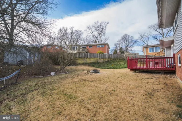 a view of a house with a yard and wooden fence