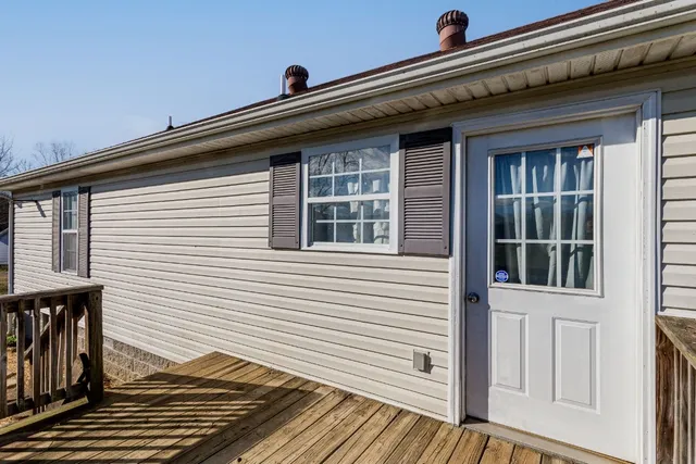 a view of a house with backyard and porch