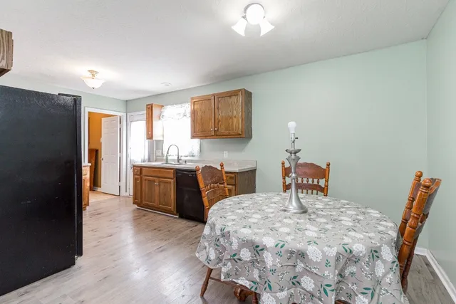 a bedroom with a bed and a view of kitchen