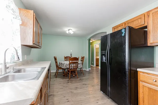 a kitchen with stainless steel appliances granite countertop a refrigerator and a sink