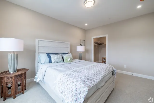 a bedroom with a bed and a night stand