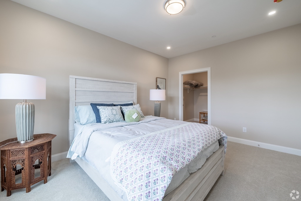 69 East Central Street, Unit 305 Natick, MA 01760 - Photo 8 of 11 a bedroom with a bed and a night stand