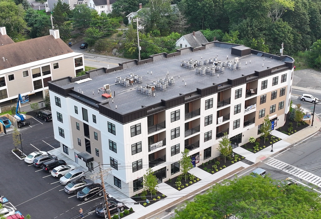 69 East Central Street, Unit 305 Natick, MA 01760 - Photo 9 of 11 a view of a building with a garden