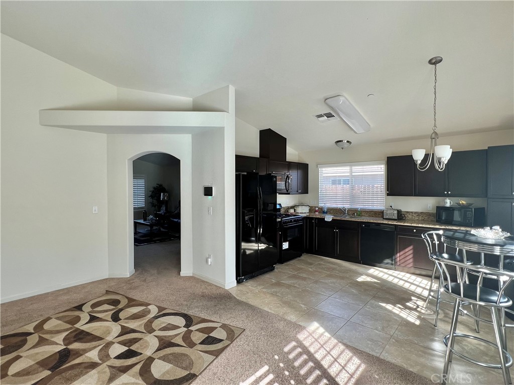 2185 Drake Avenue Merced, CA 95348 - Photo 12 of 34 a kitchen with stainless steel appliances granite countertop a refrigerator and a sink