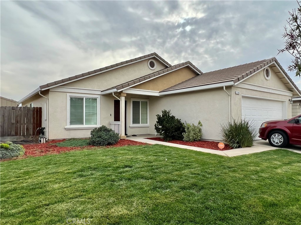2185 Drake Avenue Merced, CA 95348 - Photo 2 of 34 a front view of a house with a yard and garage