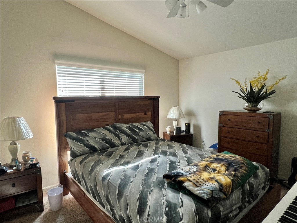 2185 Drake Avenue Merced, CA 95348 - Photo 21 of 34 a bedroom with a bed and a chandelier