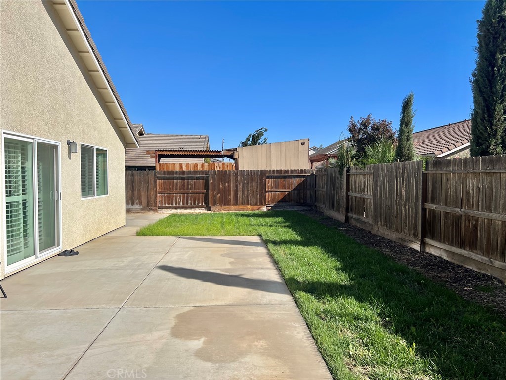 2185 Drake Avenue Merced, CA 95348 - Photo 31 of 34 a view of a house with a small yard and wooden fence