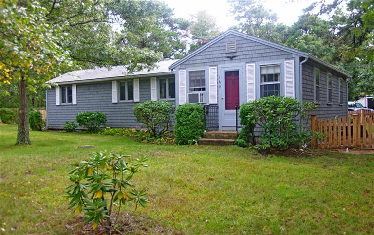 169 Foster Road Brewster, MA 02631 - Photo 1 of 14 a view of a house with a yard and plants